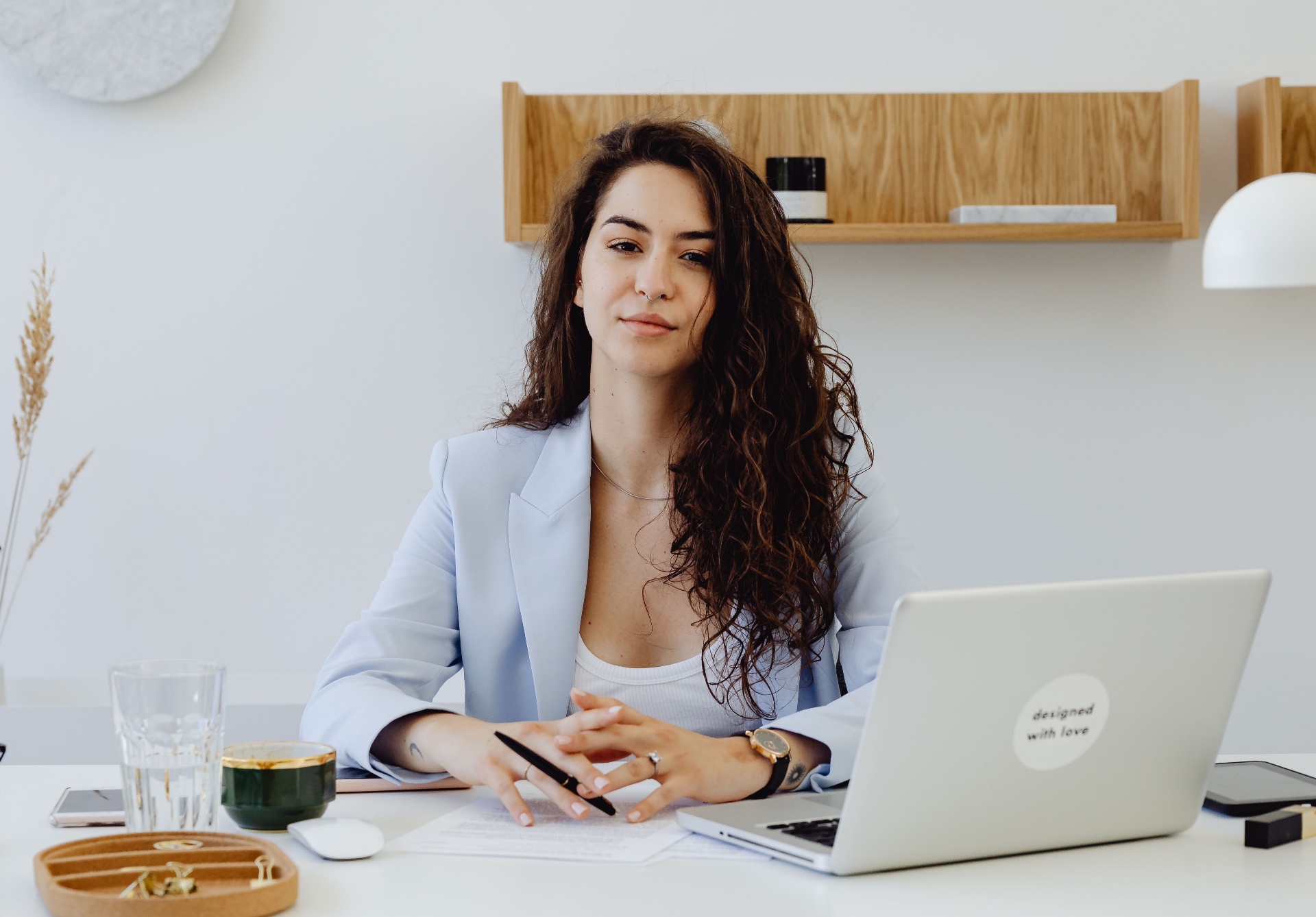 A woman waves during a video call