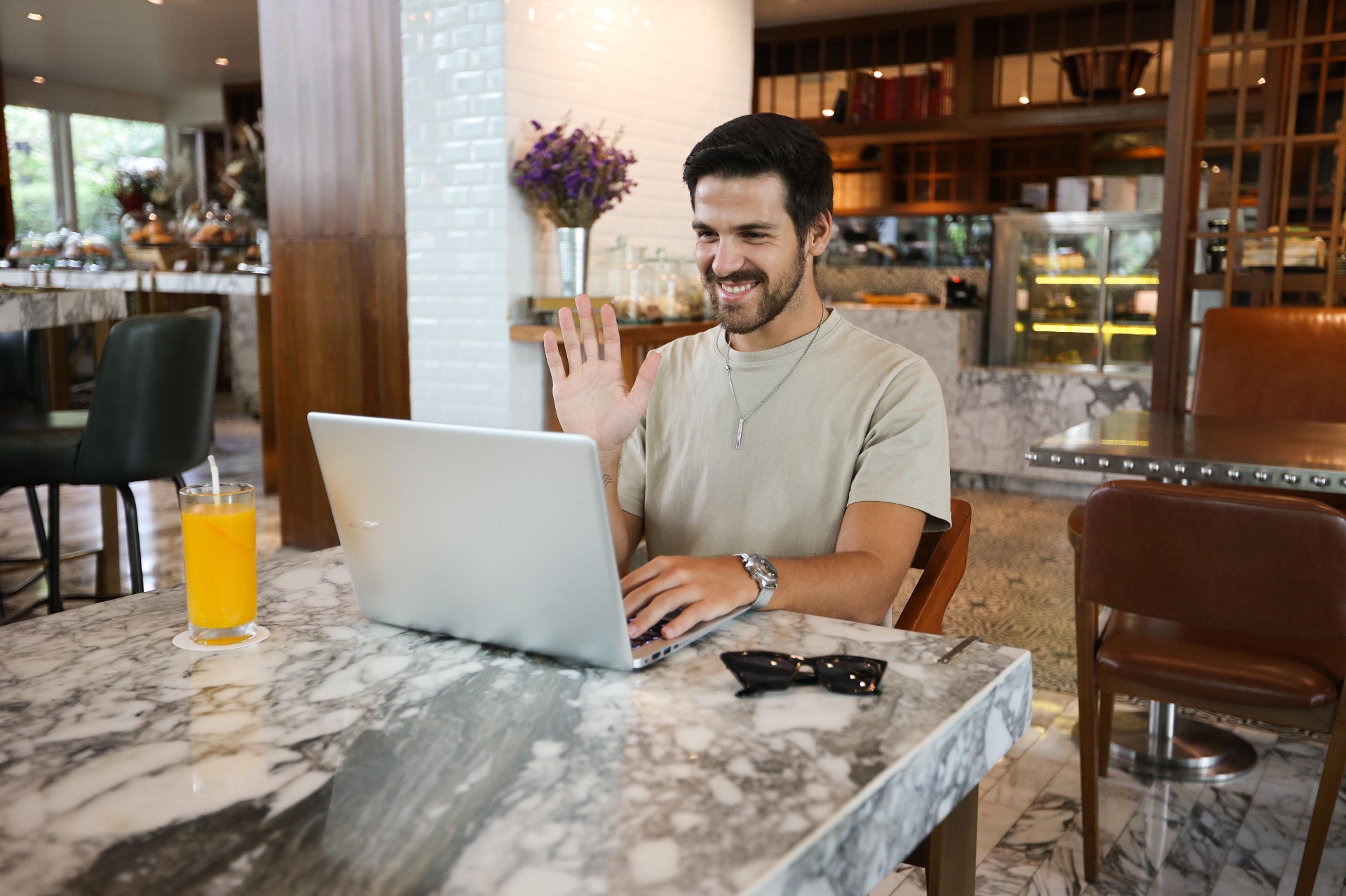 A guy smiles while using his phone